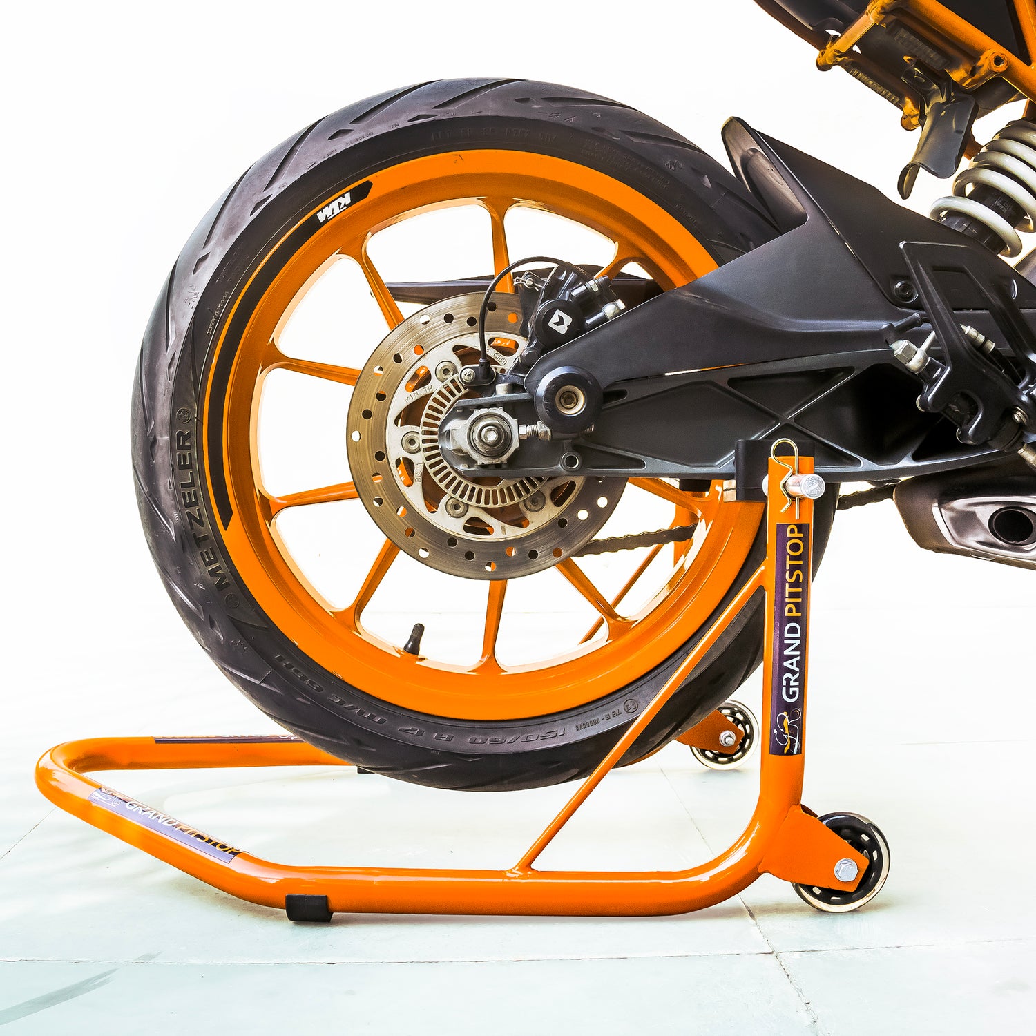 Non-Dismantlable Rear Paddock Stand With Skate Wheels (upto 350 kg) - Orange
