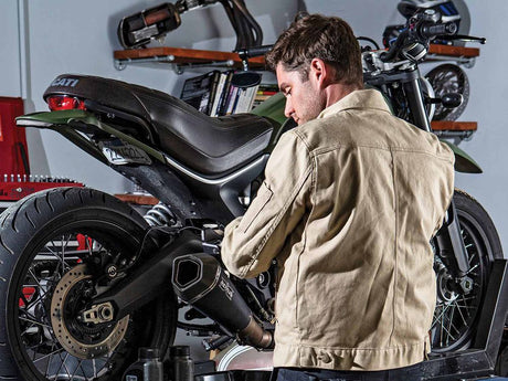 image showing a man doing at home maintenance of his bike