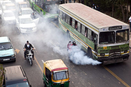 image of a street full of vehicles emitting smoke